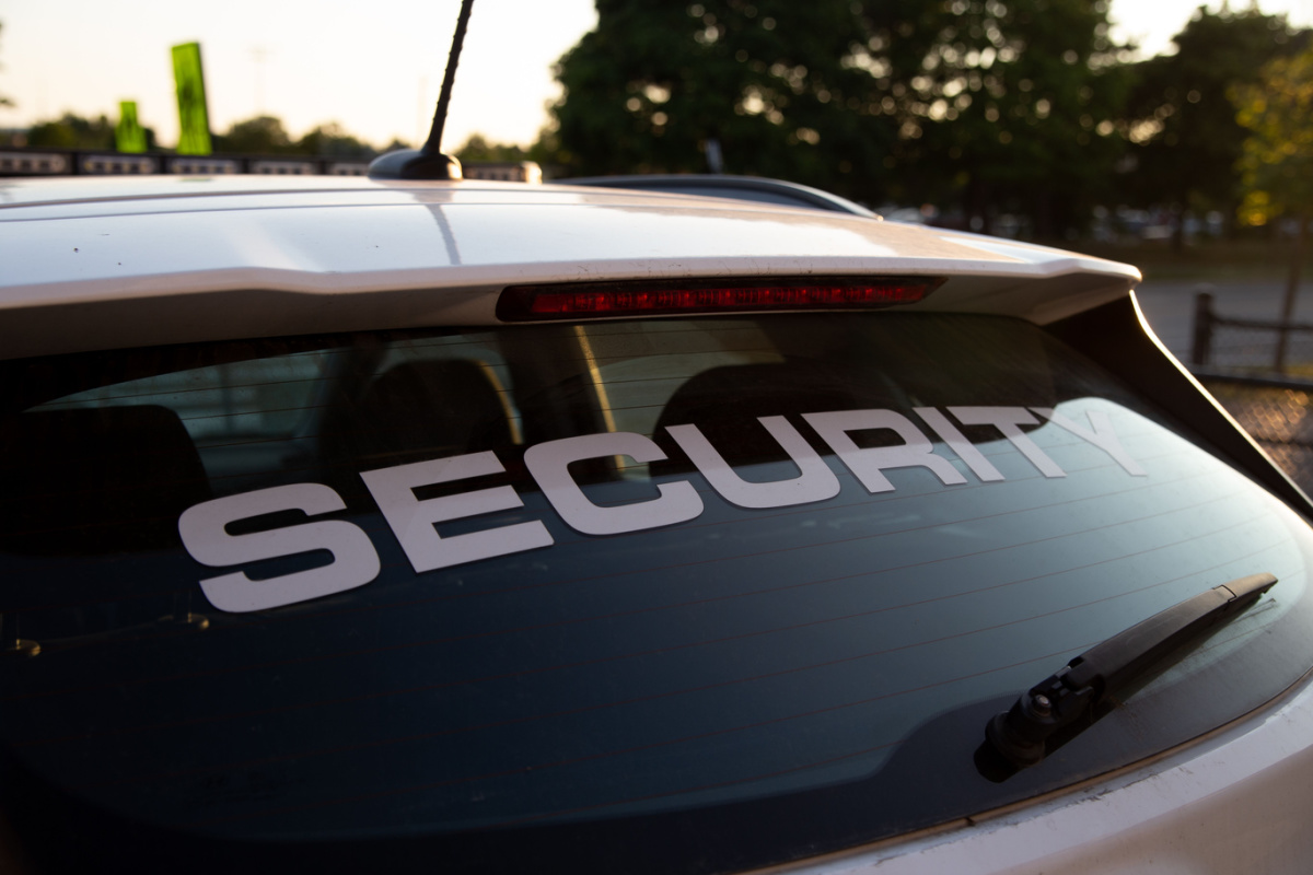 A side view of security patrol car parked outdoors