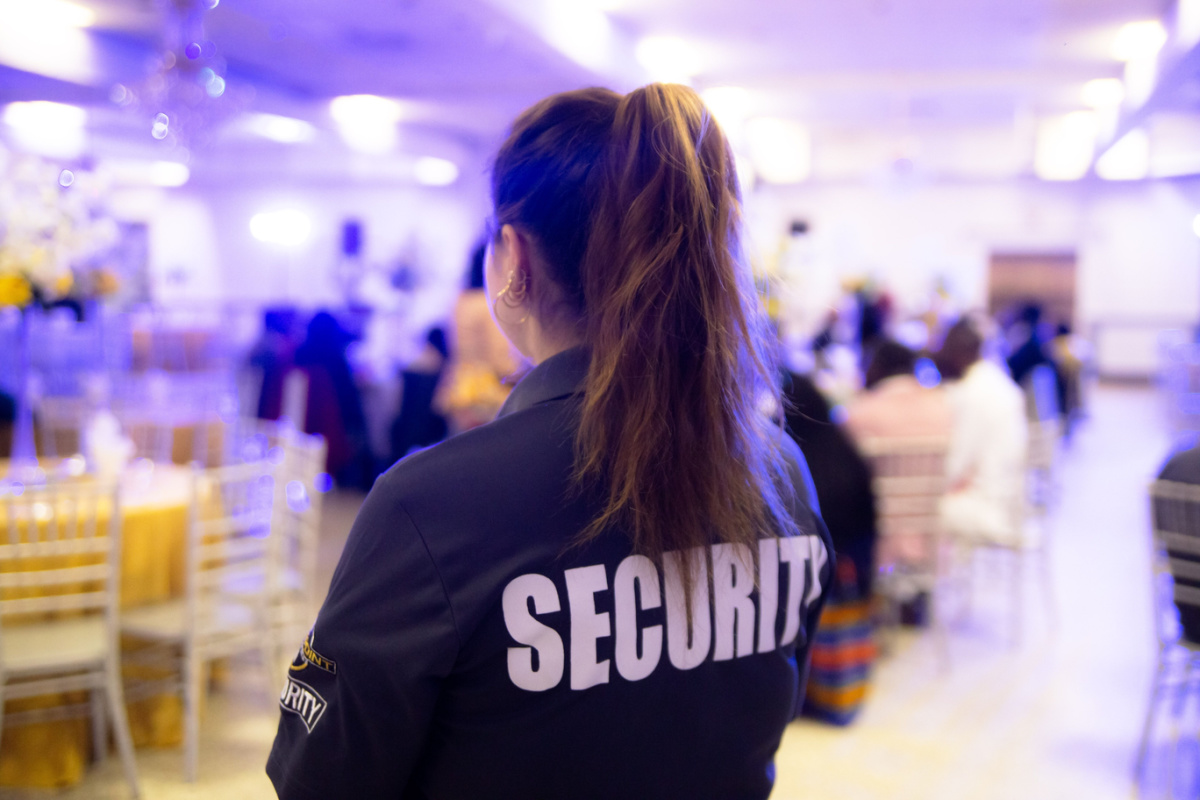 Female security guard protecting an entrance of a private event